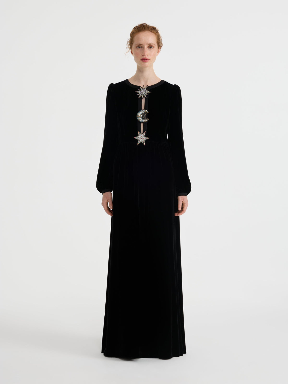 Black long sleeve velvet maxi dress with split neckline accented by three cosmic appliqués, on model front view